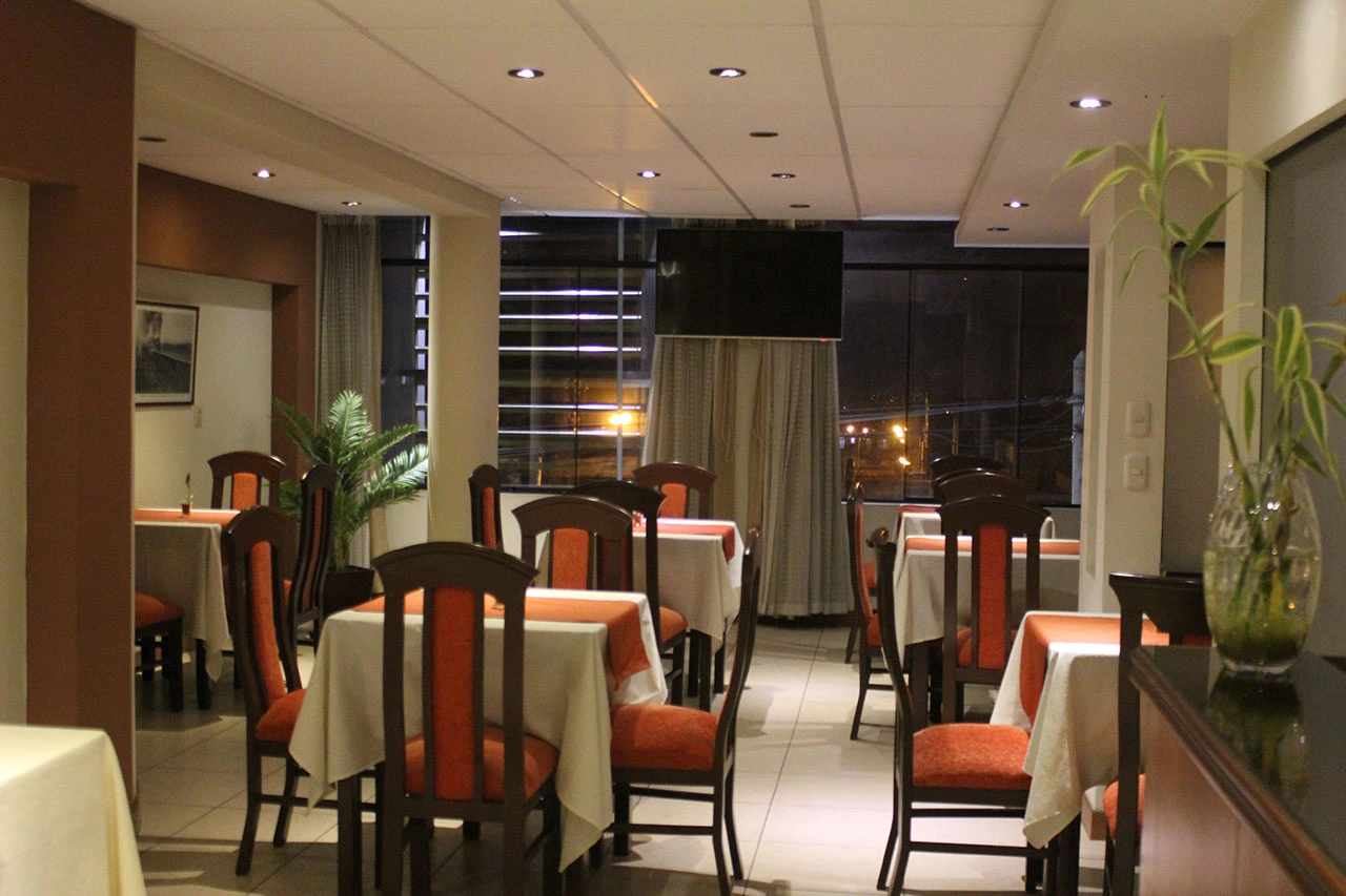 Área de comedor del restaurante con mesas y sillas elegantes